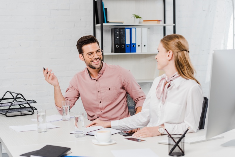happy-business-people-chatting-at-workplace-in-mod-2022-01-28-06-48-30-utc